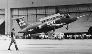The XV-4 undergoing a tethered lift test. Note the open doors on the top of the fuselage. (US Army)